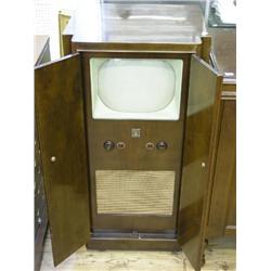 A Bush Model TUG24 television set, with 10.5ins tube and speaker in walnut two door cabinet; include