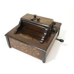 An early 20th century table top Orchestral Organette complete with 14 paper rolls  