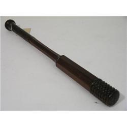 A carved mahogany baton, with hexagonal shaft and incised geometric handle, 21ins  