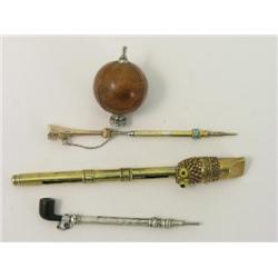 A Victorian novelty pipe propelling pencil, and three others in the form of a trumpet, ball and owl 