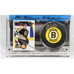 RAY BORQUE AUTOGRAPHED HOCKEY PUCK IN HOLDER.