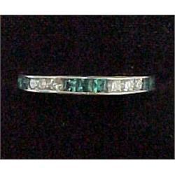 Platinum emerald and diamond band comprised of fif