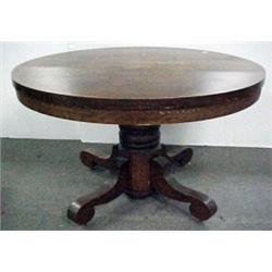Round oak dining table with pedestal base and C-sc