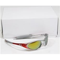 BOX OF OAKLEY STYLE RED AND SILVER SUNGLASSES.