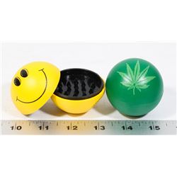LOT OF TWO GRINDERS (HAPPY FACE, PLANT LEAF)
