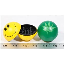 LOT OF TWO GRINDERS (HAPPY FACE, PLANT LEAF)