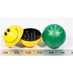 LOT OF TWO GRINDERS (HAPPY FACE, PLANT LEAF)