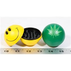 LOT OF TWO GRINDERS (HAPPY FACE, PLANT LEAF)