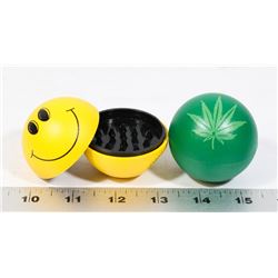 LOT OF TWO GRINDERS (HAPPY FACE, PLANT LEAF)