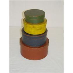 GRADUATED STACK OF 4 ROUND WOODEN PANTRY BOXES IN OLD PAINT (8 3/4" LG. TO 5 1/2" SM.)