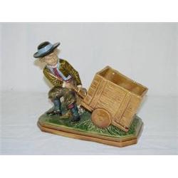 CONTINENTAL MAJOLICA FIGURE OF BOY PULLING CART (PROF. REPAIR)