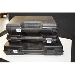 Three hard plastic pistol cases