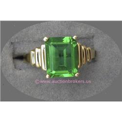 14 K YELLOW GOLD LADIES GEMSTONE RING SET WITH AN EMERALD CUT GREEN STONE 7 X 10 MM. 3.9 GRAMS.