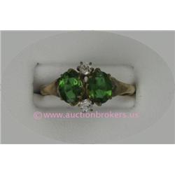10 K ROSE GOLD LADIES GEMSTONE RING SET WITH TWO OVAL CUT EMERALDS 6 X 3 MM EACH. 1.4 GRAMS.
