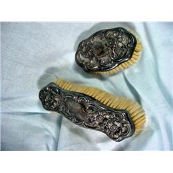 PAIR OF SILVERPLATE AND HORSEHAIR VANITY BRUSHES WITH A FLORAL DESIGN. 7" AND 3".