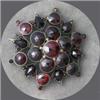 Image 1 : VINTAGE GARNET STONE BROOCH SET IN SNOWFLAKE PATTERN.