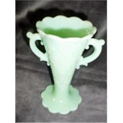 FLUTED JADEITE VASE WITH AN EMBOSSED FLORAL DESIGN AND HANDLED. 6" X 3".