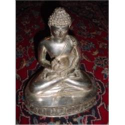 SEATED BUDDHA IN THE LOTUS POSITION MARKED "SIAM SILVER". 12" X 9.5" X 7".