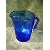 Image 1 : SHIRLEY TEMPLE COBALT BLUE GLASS PITCHER 4.5" DEPICTING FAINT IMAGE OF SHIRLEY ON SIDE OF ITEM.