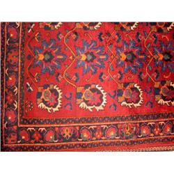 AN ORIENTAL STYLE RUG