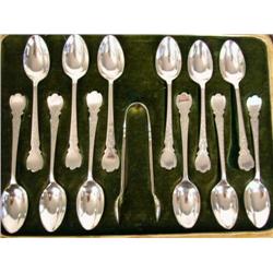 A GROUP OF TWELVE SILVER-PLATED COFFEE SPOONS AND A PAIR OF SUGAR TONGS