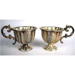 TWO GILT SILVER HANDLED FOOTED CUPS