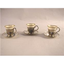A SET OF TWELVE LENOX DEMITASSE LINERS AND STERLING SILVER HOLDERS