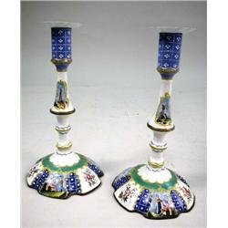 A PAIR OF ROCOCO POLYCHROME-DECORATED BATTERSEA OR SOUTH STAFFORDSHIRE CANDLESTICKS