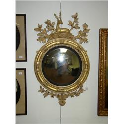 A GEORGE III CARVED GILTWOOD AND PART EBONIZED LOOKING GLASS