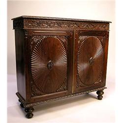 A COLONIAL CARVED TROPICAL HARDWOOD CABINET