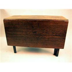 A GEORGE III OAK DROP LEAF TABLE