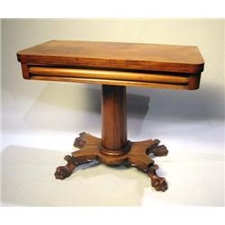 AN CLASSICAL MAHOGANY CARD TABLE RESTING ON PEDESTAL BASE AND CLAW FEET