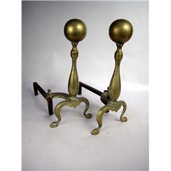 A PAIR OF BRASS CANNONBALL ANDIRONS AND FIRE FENDER