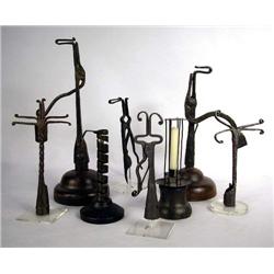 A GROUP OF FOUR IRON RUSH LIGHT HOLDERS