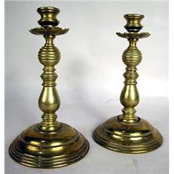 A PAIR OF BRASS ROUND BASE CANDLESTICKS