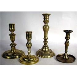 A GROUP OF FOUR BRASS CANDLESTICKS