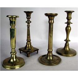 A GROUP OF FOUR BRASS CANDLESTICKS