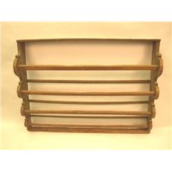 A BROWN-PAINTED PINE HANGING PLATE RACK