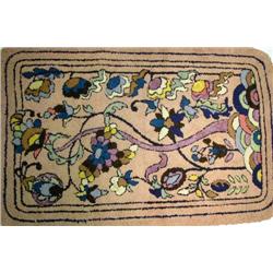 A POLYCHROME-DECORATED AND FLORAL RAG RUG