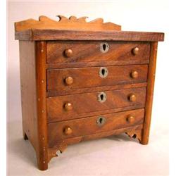 A LATE FEDERAL STYLE MINIATURE MAHOGANY AND MAPLE CHEST OF DRAWERS