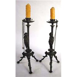 TWO CAST BRONZE FIGURAL CANDLESTICKS