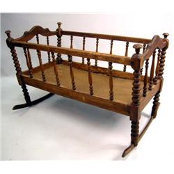 A VICTORIAN SPOOL TURNED MAPLE ROCKING CRADLE