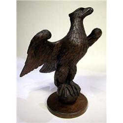 A CARVED OAK EAGLE PERCHED ON SPHERE