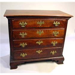 A CHIPPENDALE FIGURED WALNUT CHEST OF DRAWERS