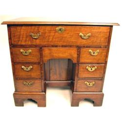 A GEORGE II WALNUT KNEEHOLE BUREAU