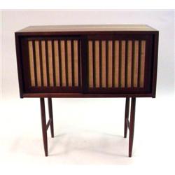 A GEORGE NAKASHIMA WALNUT CABINET ON FOUR LEGS WITH GRASS CLOTH DOORS