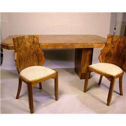 AN ART DECO FIGURED WALNUT DINING TABLE