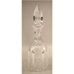 A COLORLESS GLASS DECANTER WITH STOPPER