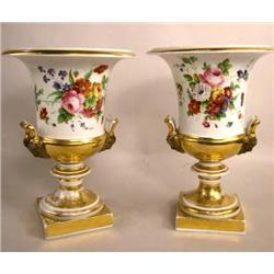 A PAIR OF NEOCLASSICAL FLORAL-DECORATED PARCEL-GILT URNS