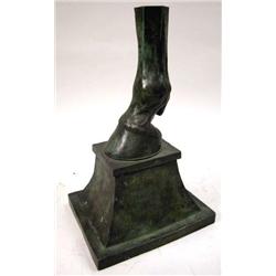 A CAST BRONZE SCULPTURE OF A HORSE'S HOOF